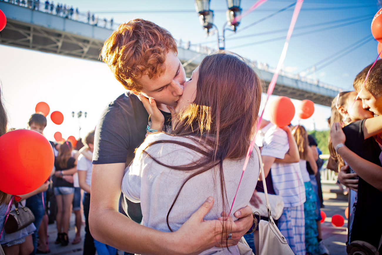 Couples kiss as part of a flash mob in the town of Tyumen on the World Kissing Day, 2012.