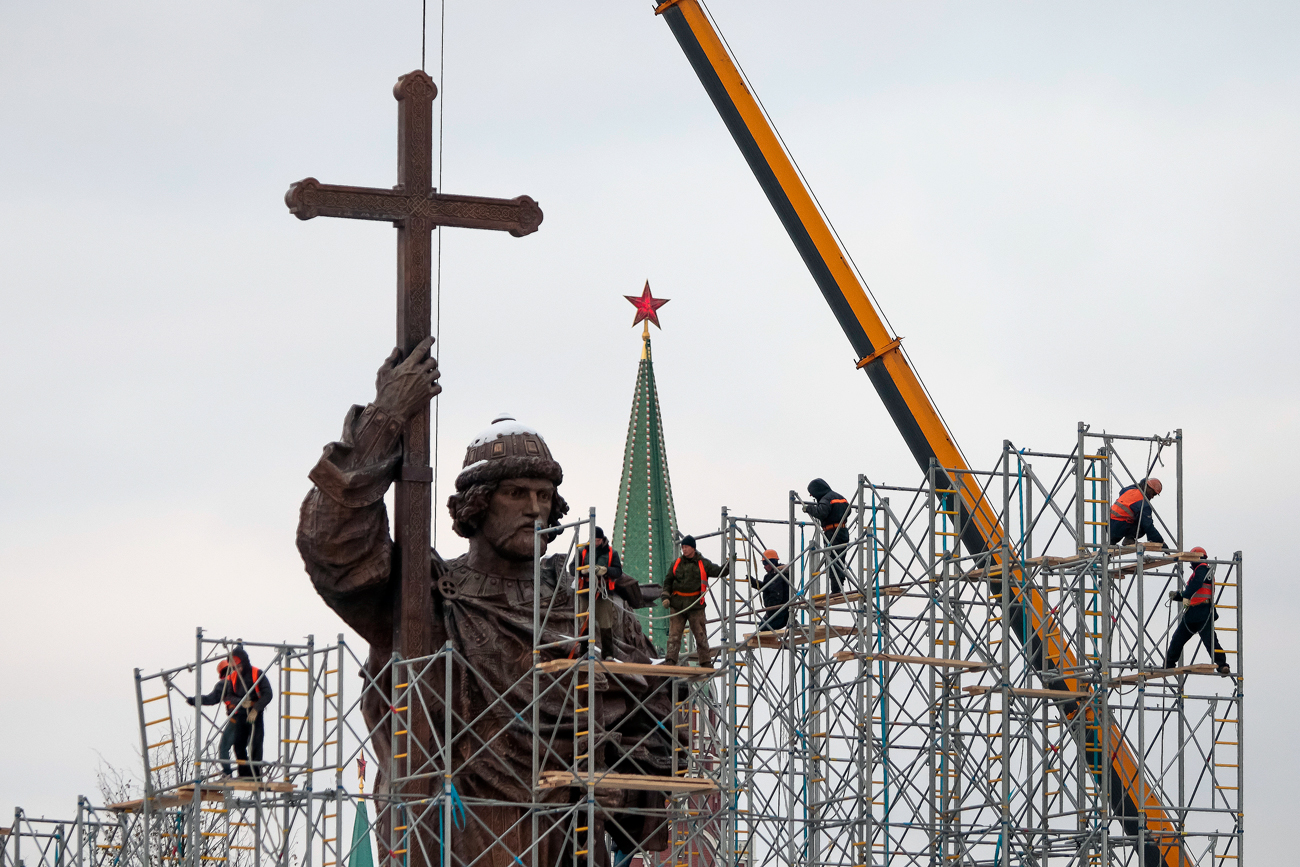 Градежни работници го расклопуваат скелето околу споменикот на Владимир Велики, кој го донесе христијанството во паганската Киевска Русија во 10 век. Москва, Русија.