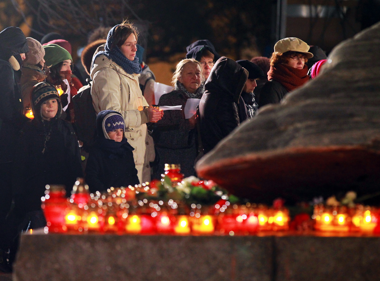 People in the Return of Names action stand in the queue on the rostrum at the Solovetsky Stone on Lubyanka Square in Moscow. The event is held each year on the eve of the Day of Remembrance of the Victims of Political Repression, at which anyone can read lists with names of victims in the Great Purge of 1937-1938.