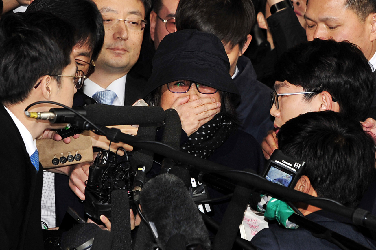 Choi Soon-sil (C), who is alleged of having meddled in state affairs and peddled influence on various state projects by exploiting her friendship with South Korean President Park Geun-hye, as she arrives to the Seoul Central District Prosecution Office for questioning in Seoul.
