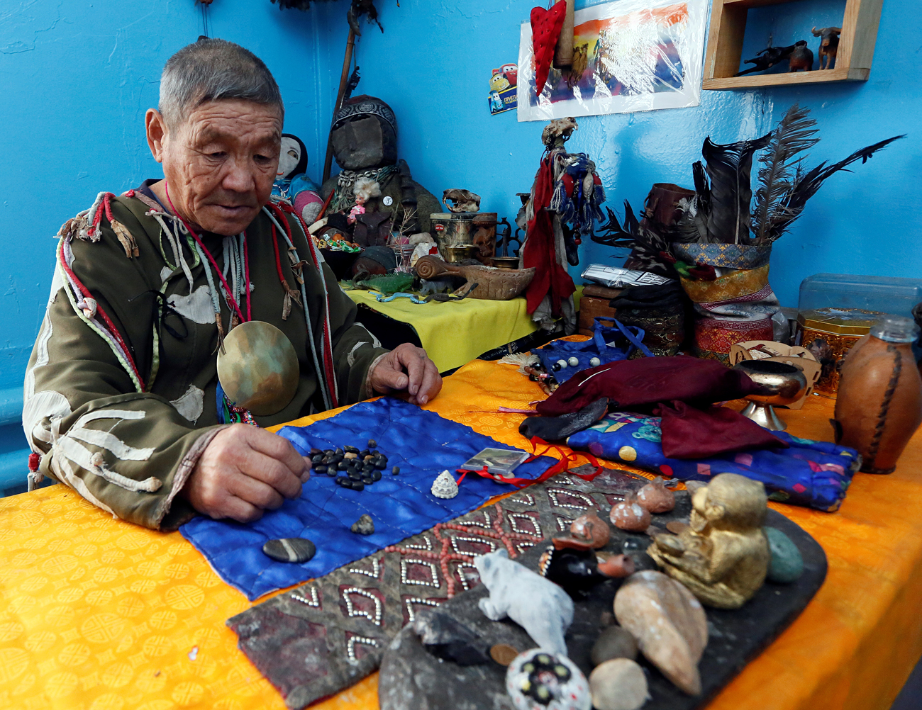 Vasily Tyulyush, a shaman representing the so-called Adyg Eeren (Bear Spirit) society, sits at a table while waiting for visitors inside a residence in the town of Kyzyl, the administrative centre of the Republic of Tuva (Tyva region) in Southern Siberia, Russia. The region is inhabited by Tuvans, historically cattle-herding nomads, who nowadays practise two main confessions - Buddhism and Shamanism.