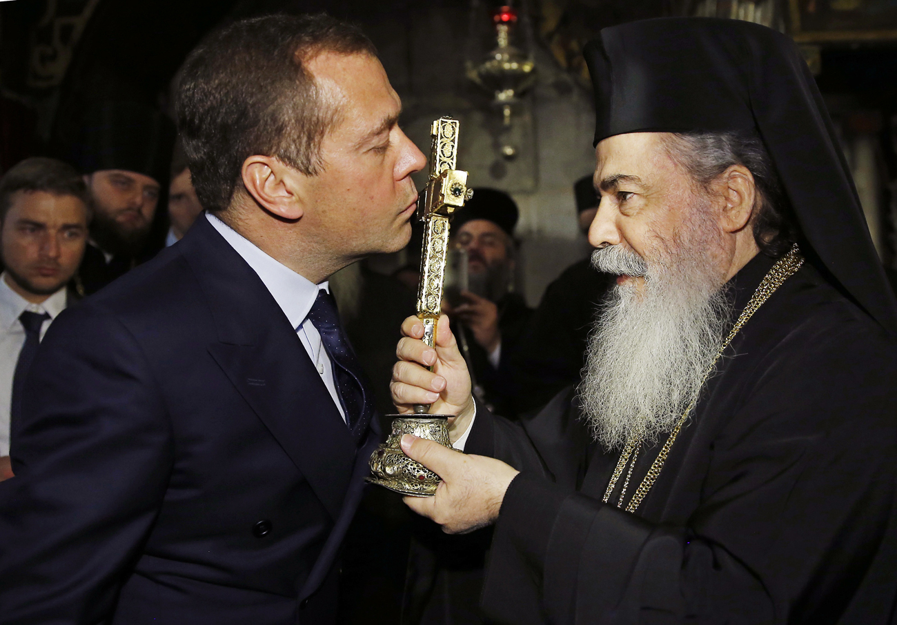 El primer ministro Dmitri Medvédev besa un crucifijo durante la visita que realizó al Santo Sepulcro de Jerusalén.