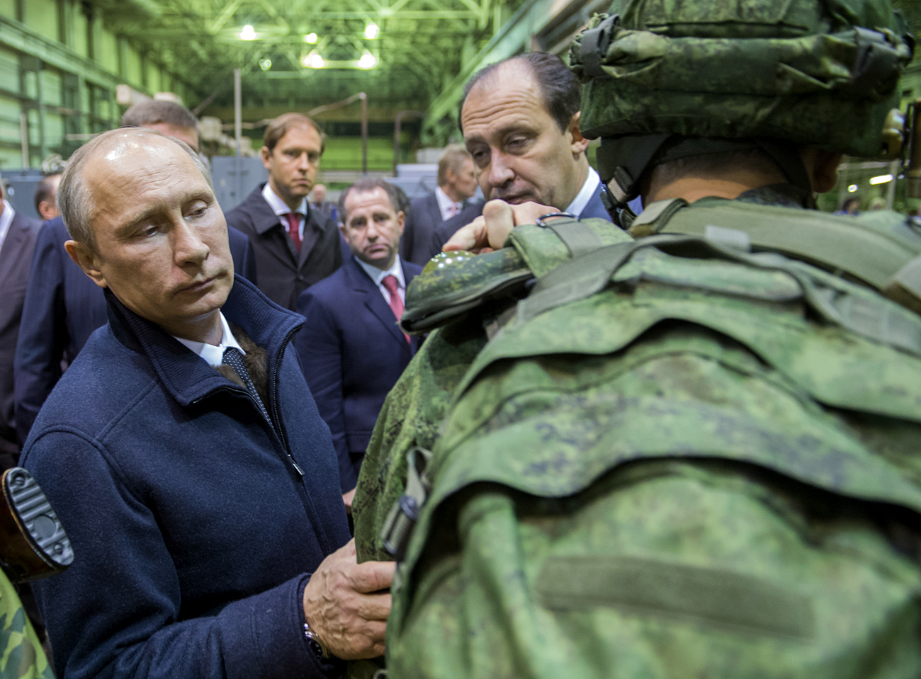 Russian President Vladimir Putin, left, reviews examples of 'Ratnik' modern military garment during a working visit to OJSC 'Kalashnikov Concern' in Izhevsk.