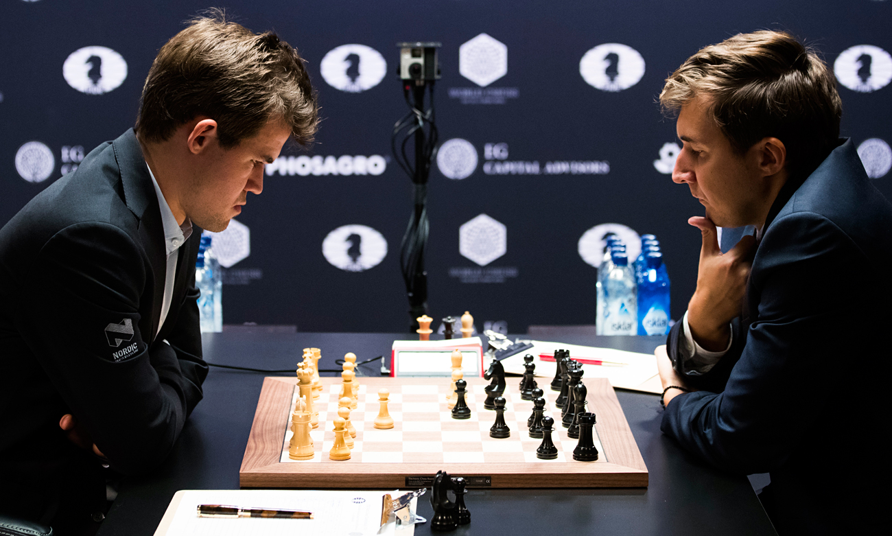 Chess players Magnus Carlsen (L) of Norway, the reigning world chess champion, and Sergey Karjakin of Russia contemplate their moves during round 1 of the World Chess Championship in New York. The players will face off in 12 games between today and Nov. 30 2016.