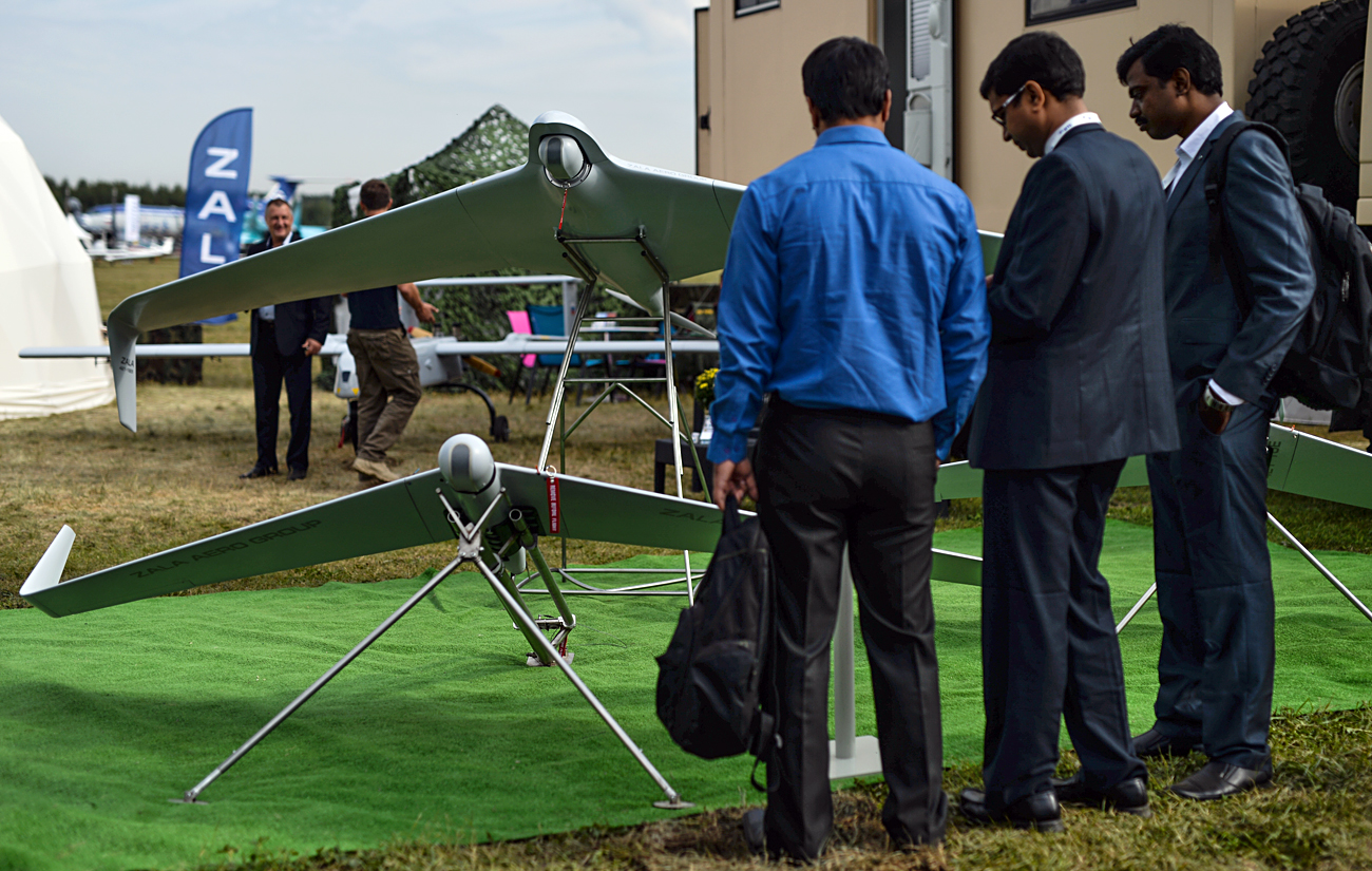 Visitors look at the Zala 421-16E5 UAV, presented by Zala Aero Group, part of the Kalashnikov corporation, at the MAKS-2015 air show in Zhukovsky in the Moscow Region.