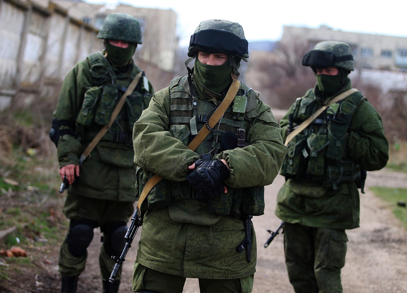 Masked servicemen stand near the territory of the 36th separate brigade of the Ukrainian Navy coastal defence at the naval base in Perevalnoe, Crimea in March 2014.