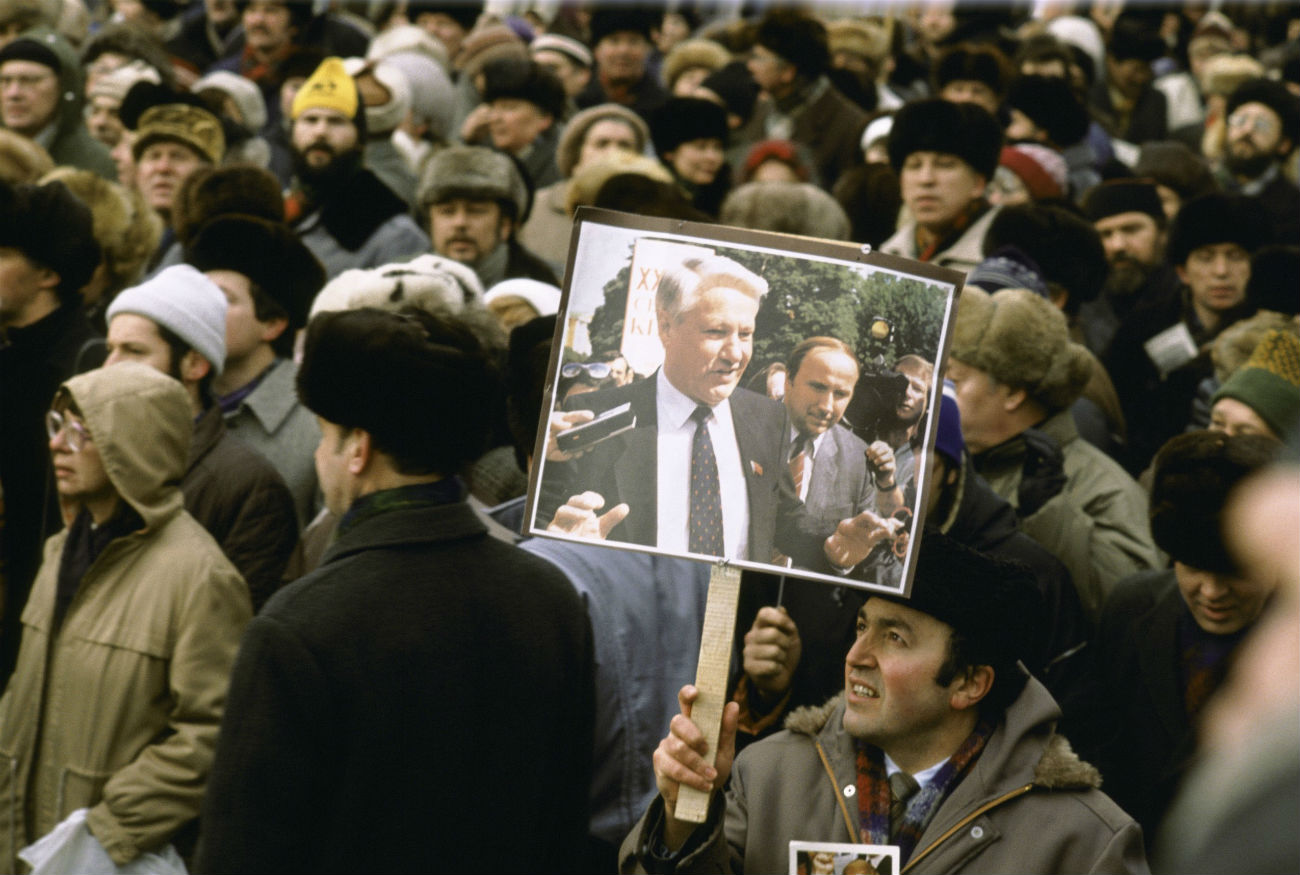 Homem segura cartaz com foto de Iéltsin em uma manifestação pró-democracia em março de 1991, em Moscou
