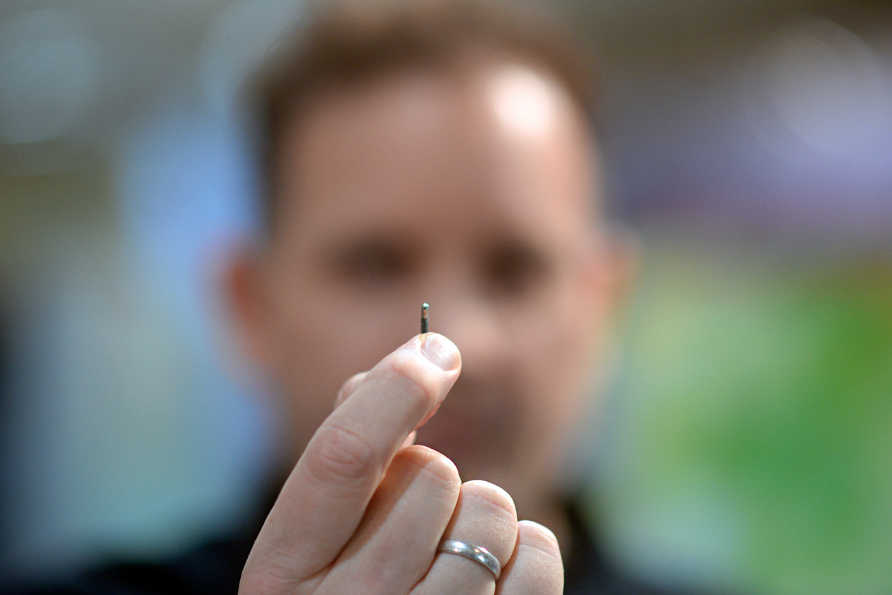 An employee of Digiwell shows a RFID-Chip which can be engrafted in a person's hand at the CeBIT trade fair, the world's biggest computer and software fair, in Hannover March 13, 2016.