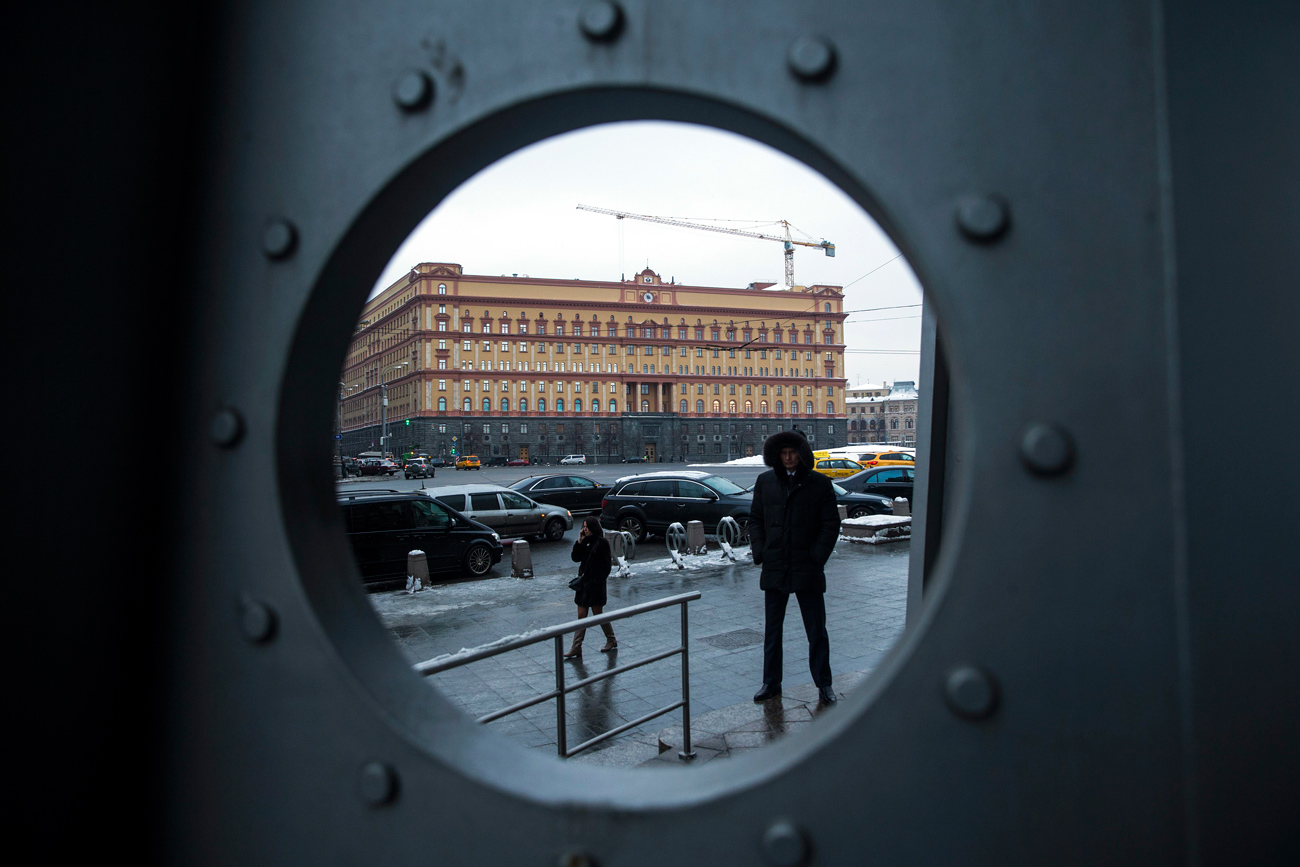 A security man stands in Lubyanka Square, with the main building of the Russian Federal Security Service, former KGB headquarters, in the background.