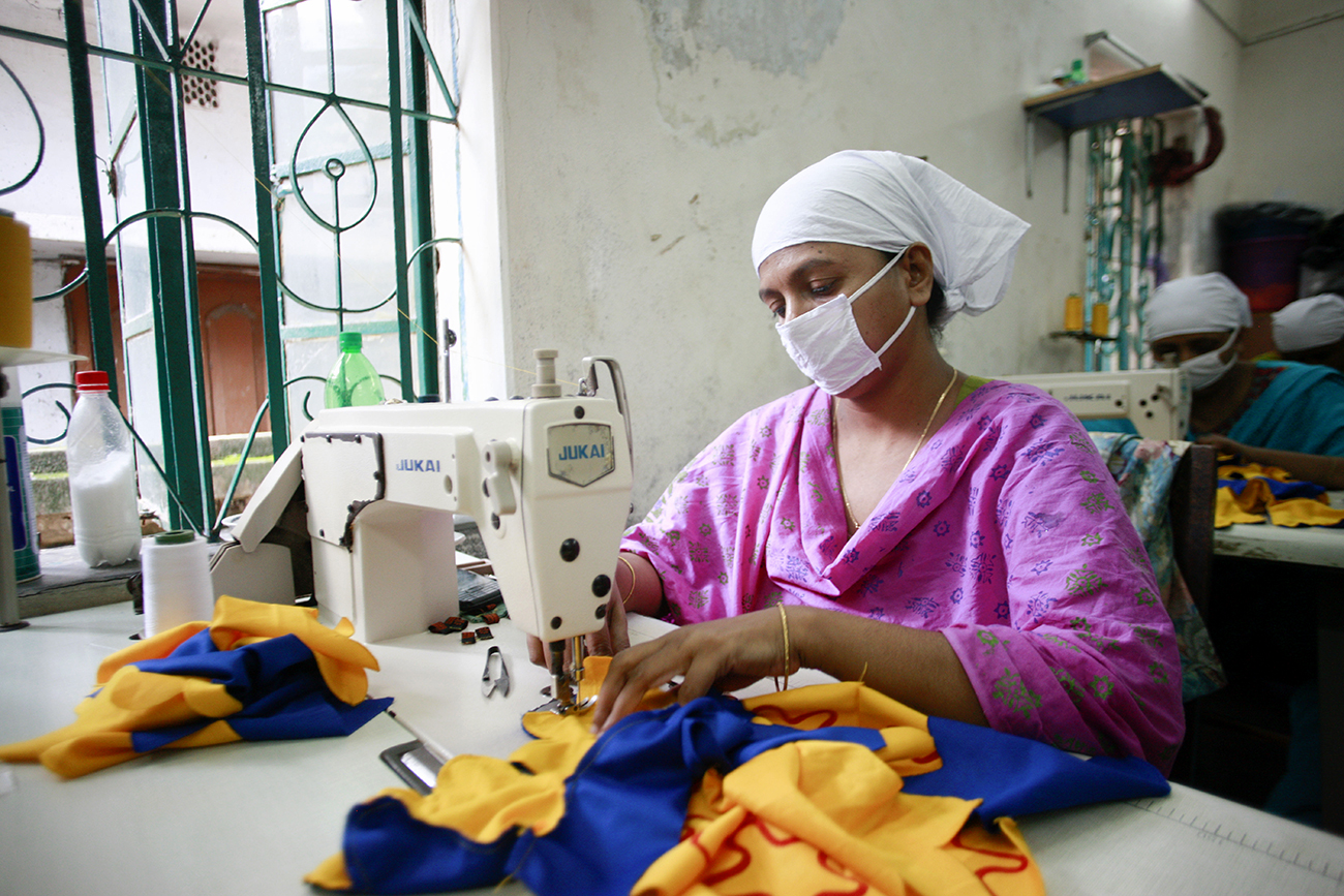 A Bangladeshi worker swings fabrics for toys at a small factory in Dhaka, Bangladesh.