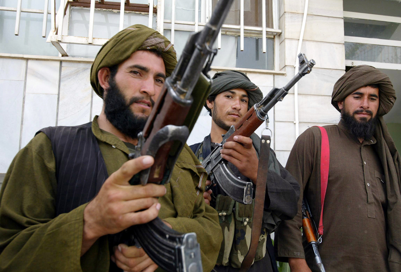 Taliban militants pose for the media after they join the Afghan government in Herat, May 22, 2010.