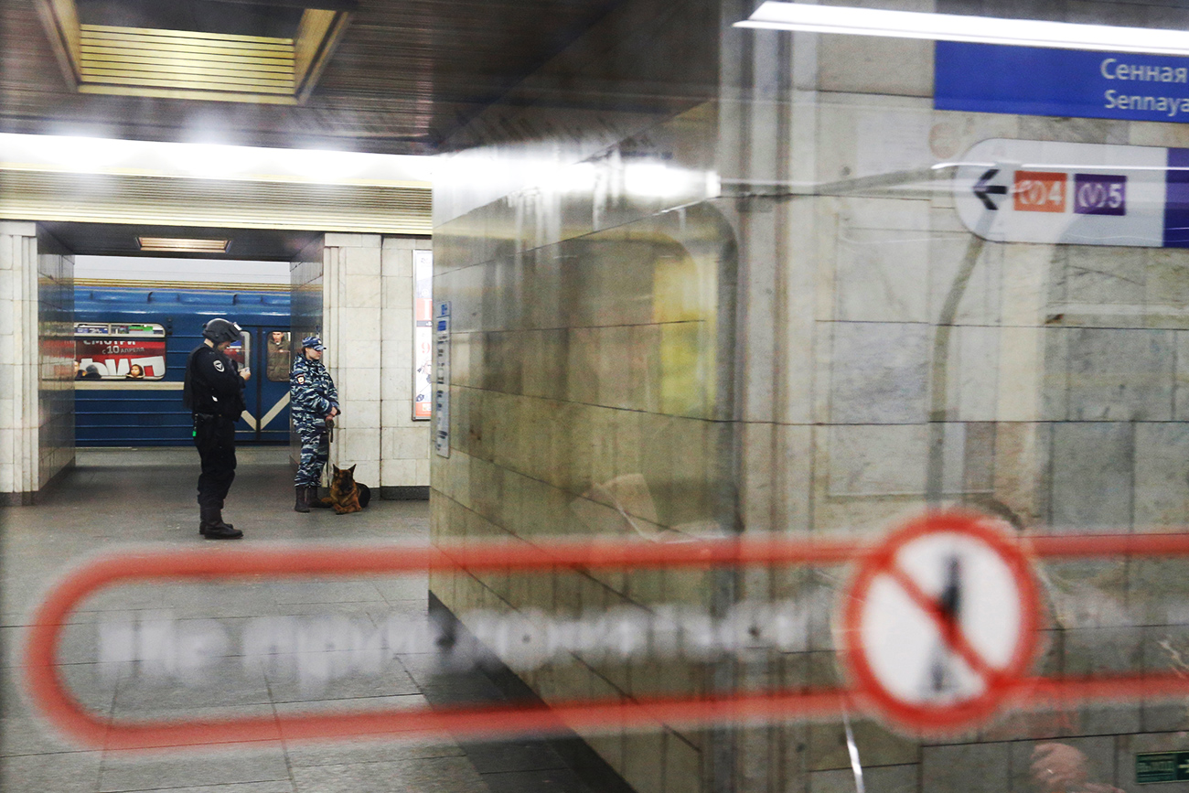 Police officers are seen through the window of a train at Sennaya Ploshchad metro station which was closed over an anonymous call of a bomb threat after the deadly blast in the underground, in St. Petersburg, April 4, 2017.