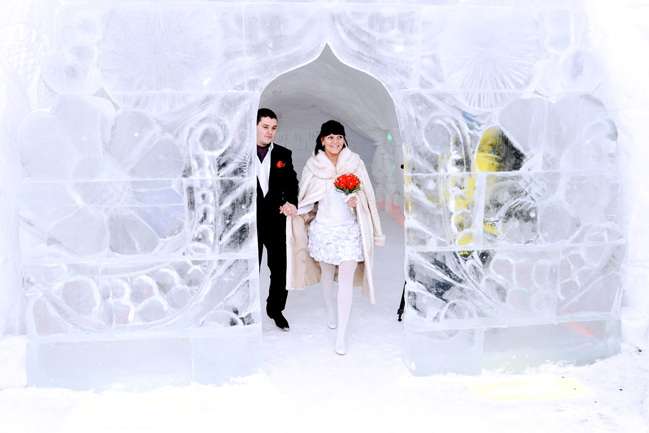 MURMANSK REGION, RUSSIA. FEBRUARY 29, 2012. Newly weds at an Ice Wedding Palace built as part of the Snow Village at the foothills of the Khibiny Mountains, near Kirovsk.