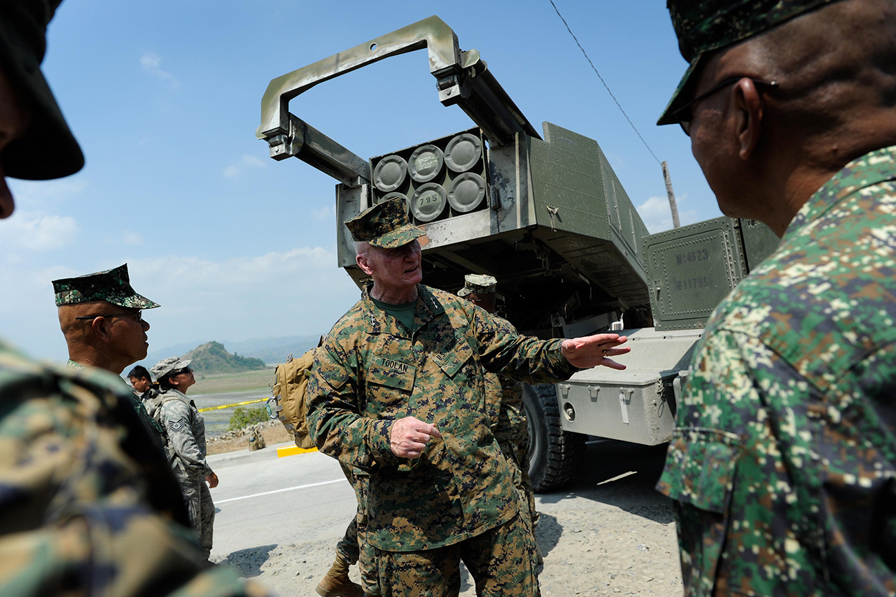 CROW VALLEY, PHILIPPINES - APRIL 14: U.S. Marines Expeditionary commander in the Pacific Lieutenant General John Toolan (C) stands behind a High Mobility Artillery Rocket System (HIMARs) during joint military exercises on April 14, 2016
