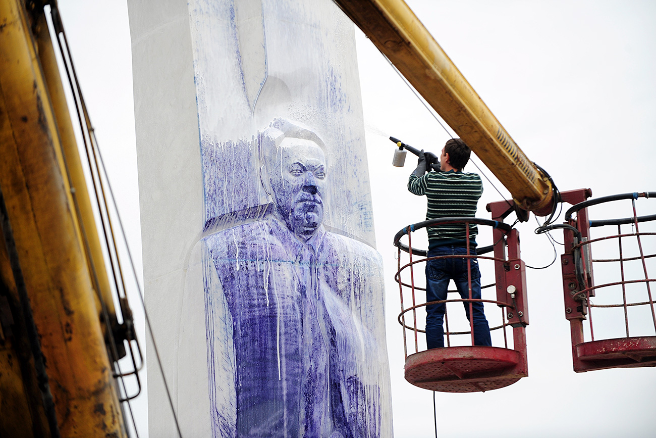 Cleaning the memorial to first Russian president Boris Yeltsin in Yekaterinburg partially destroyed and sprayed with paint.