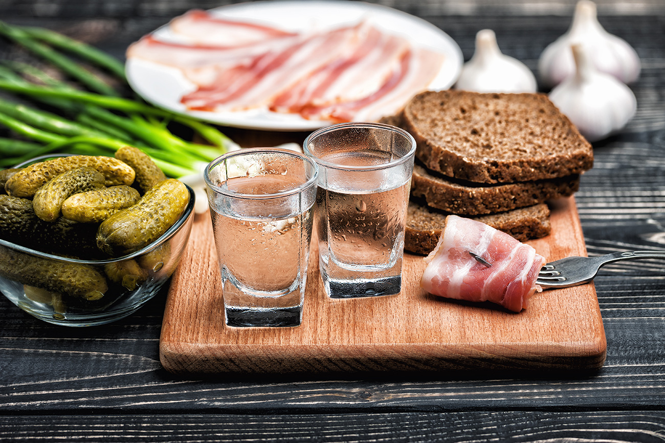 Russian vodka with traditional black bread and pickles.