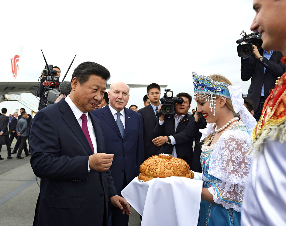 Chinese president Xi Jinping takes part in a traditional bread and salt ceremony upon his arrival before attending the Shanghai Cooperation Organization (SCO) and the BRICS summits in Ufa, Russia on July 8, 2015. Source: Reuters