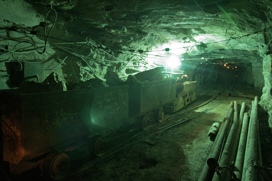 Rolling stock makes its way through the mine tunnels to facilitate the delivery of ore to the processing units.