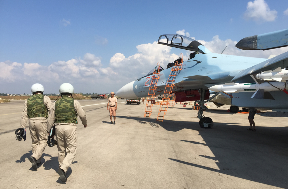 The crew of a Russian Su-30 fighter prepare to take off at Hmeimim aerodrome in Syria.