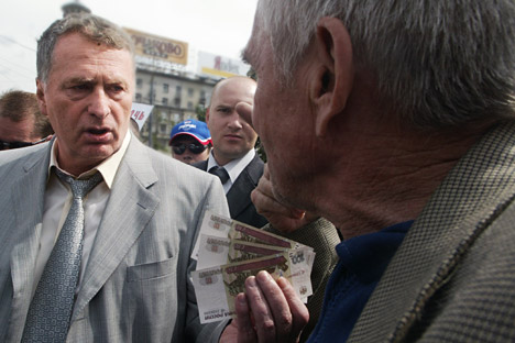 The Liberal Democratic Party of Russia (LDPR) has raised 127 million rubles ($4 million) since the reform on founding political parties. Pictured: LDPR leader Vladimir Zhirinovsky (right) giving money to ordinary people during a meeting in Moscow. So