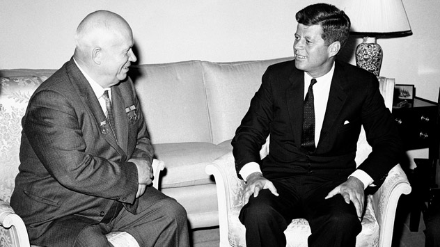 Pictured (L-R): Soviet Premier Nikita Khrushchev and President John F. Kennedy talk in the residence of the U.S. Ambassador in a suburb of Vienna in June, 1961. Source: AP