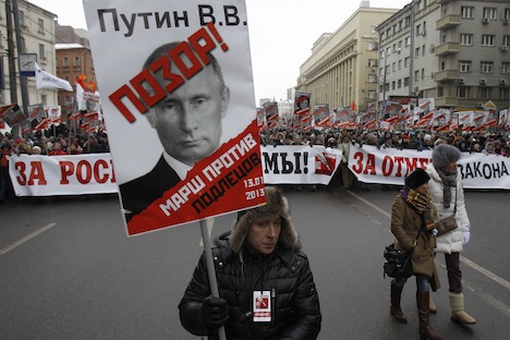 Russians turned up for a march in Moscow on Sunday to protest against a ban on adopting Russian children by Americans. The placard featuring a portrait of Russian President Putin says, "Shame on Putin! March against scoundrels". Source: Reuters