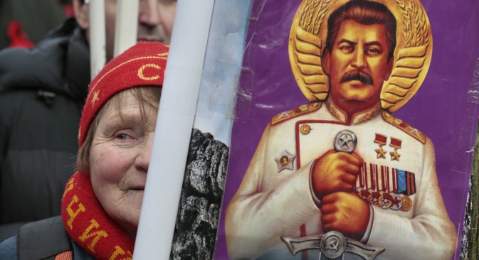 A women holds a portrait of the Soviet leader Josef Stalin, during a communists rally to mark Defenders of the Fatherland Day in Moscow, Russia, Saturday, Feb. 23, 2013. Source: AP