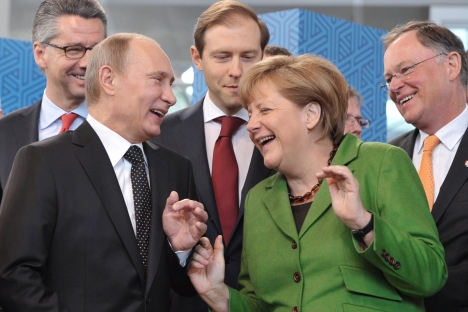 German Chancellor Angela Merkel, right, and Russian President Vladimir Putin, left, laugh as they open Hanover Fair, in Hannover, central Germany, on Monday, April 8, 2013. Source: AP