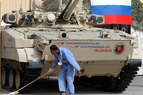 A man cleans the exhibition stand of the BMP-3 Russian tank during the opening day of the International Defence Exhibition & Conference, IDEX, in Abu Dhabi, United Arab Emirates. Source: AP