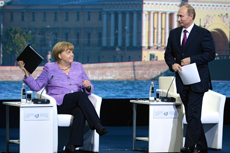German Chancellor Angela Merkel and Russian President Vladimir Putin discussed the global economics in St. Petersburg. Source: Kommersant