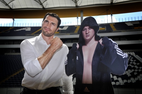 Wladimir Klitschko (L) poses with a photo of his opponent, Alexander Povetkin, at the Commerzbank Arena stadium in Frankfurt, July 19, 2010. The Klitschko-Povetkin fight could take place in 2010, but it was repeatedly postponed. Source: AP
