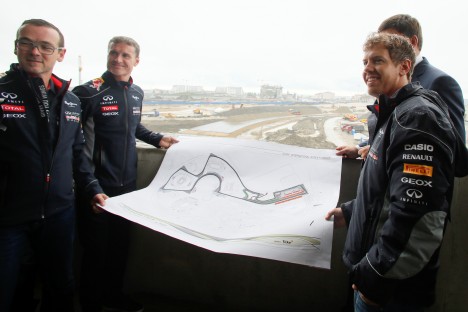World Champion Sebastian Vettel (foreground right) and a team ambassador David Coulthard (second left) with officials hold a map of the track while visiting the Sochi Olympic Park and site of Russia’s first Grand Prix in Sochi, on April 22. Source: AP