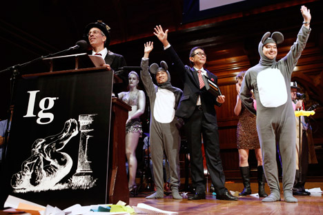 Master of ceremonies Marc Abrahams, left, introduces the winners of the Medicine Prize, Xiangyuan Jin, right mouse, of China, Masanori Niimi of Japan and Masateru Uchiyama of Japan during the annual Ig Nobel prize ceremony at Harvard University Thursday, Sept. 12, 2013 in Cambridge, Mass. Source: AP