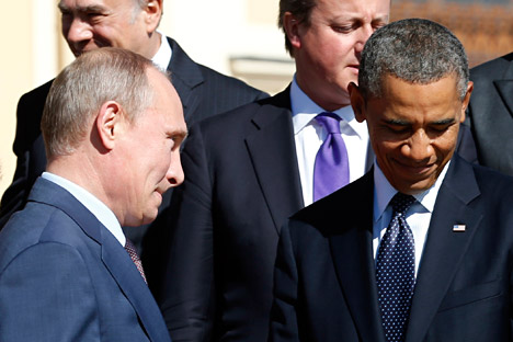Russian President Vladimir Putin (L) walks past U.S. President Barack Obama (R) and British Prime Minister David Cameron during a group photo at the G20 Summit in St. Petersburg September 6, 2013. Source: Reuters