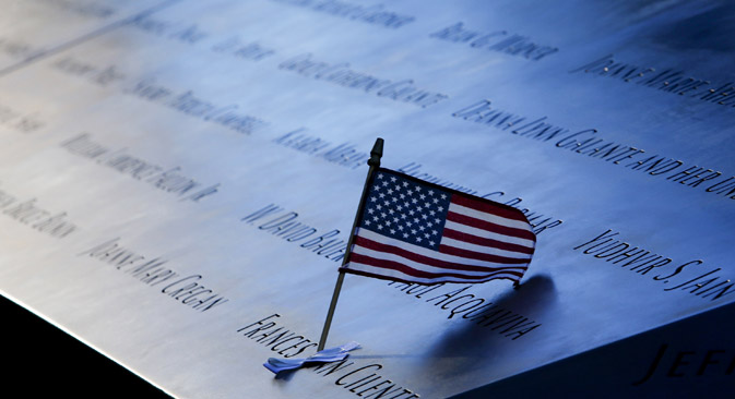 An American flag in the plaque of names on the edge of the North Pool of the 9/11 Memorial in New York. Source: Reuters