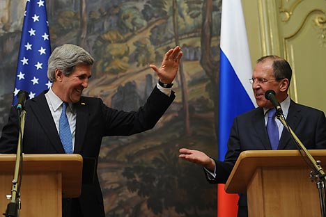 U.S. Secretary of State John Kerry (L) high-fives Foreign Minister Sergei Lavrov (R) during a recent Russian Foreign Ministry briefing. Source: Photoshot / Vostock-Photo