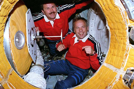 View of the Mir 19 commander Anatoly Solovyev (R) and flight engineer Nikolai Budarin preparing to close the hatch to the docking module which leads to the Mir space station, 1995. Source: NASA