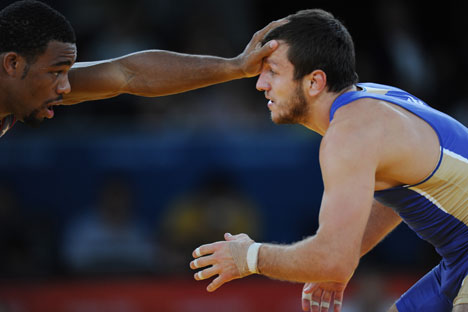 From right: Russia's Denis Tsargush and Jordan Burroughs of the United States compete at the Olympic Games in London. Source:  RIA Novosti / Vladimir Baranov