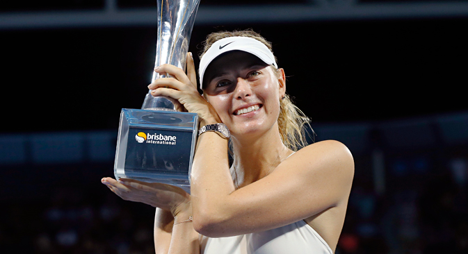 Maria Sharapova holds the Brisbane International tennis tournament women's singles trophy after defeating Ana Ivanovic of Serbia in Brisbane, January 10, 2015. Source: Reuters