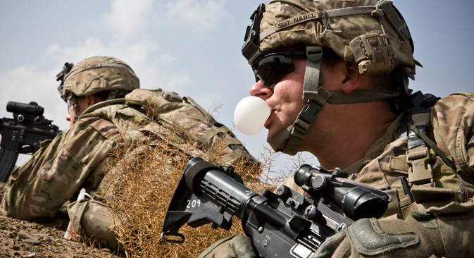 A U.S. Army soldier with Charlie Company, 36th Infantry Regiment, 1st Armored Division blows a bubble with his chewing gum during a mission near Command Outpost Pa'in Kalay in Maiwand District, Kandahar Province, 2013. Source: Reuters