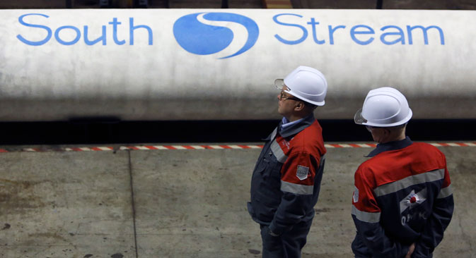 Employees stand near pipes made for the South Stream pipeline. Source: Reuters