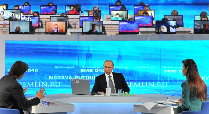 Vladimir Putin spent more than four hours answering questions from the public on various issues in the annual broadcast. Source: EPA
