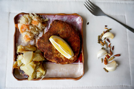 Pork schnitzel served with potatoes and pickled cabbage. Source: Anna Kharzeeva