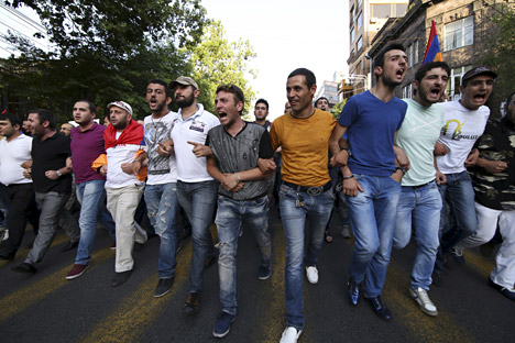 Protesters march during a rally against a recent decision to raise public electricity prices in Yerevan, Armenia. Source: Reuters