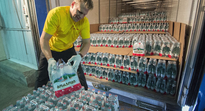 A storage area employee unloading a shipment of Borzhomi mineral water at Mamontovsky Customs Post, outside Moscow, 2013. Source:  Maksim Blinov / RIA Novosti