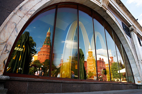 The walls and towers of the Kremlin are reflected in a window of a closed McDonald's restaurant. Source: Reuters