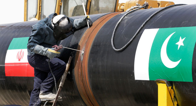  An Iranian worker welds two gas pipes at the beginning of construction of a pipeline to transfer natural gas from Iran to Pakistan, 2013. Source: AP