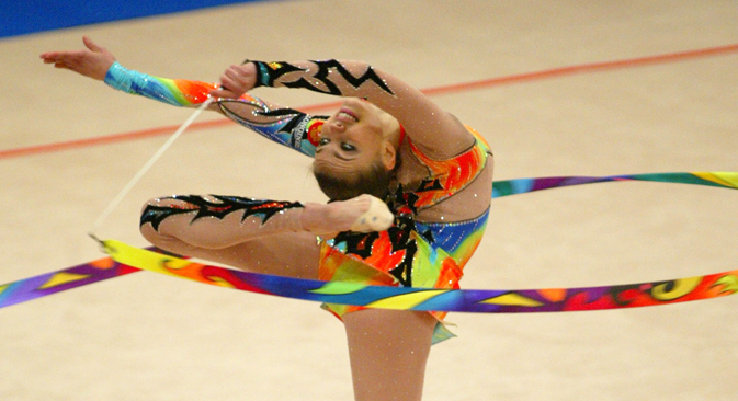 Alina Kabayeva performs with the ribbon during her routine in the team competition at the European Rhythmic Gymnastics Championship in Kiev, June 5, 2004. Source: Reuters