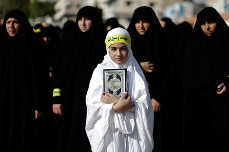 Una chica libanesa sostiene una copia del Corán en una protesta en Líbano. Fuente: AP.