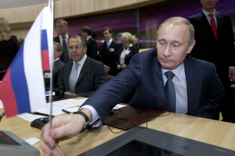 Vladímir Putin con Serguéi Lavrov (al fondo), ministro de Asuntos Exteriores de Rusia. Fuente: ITAR-TASS.